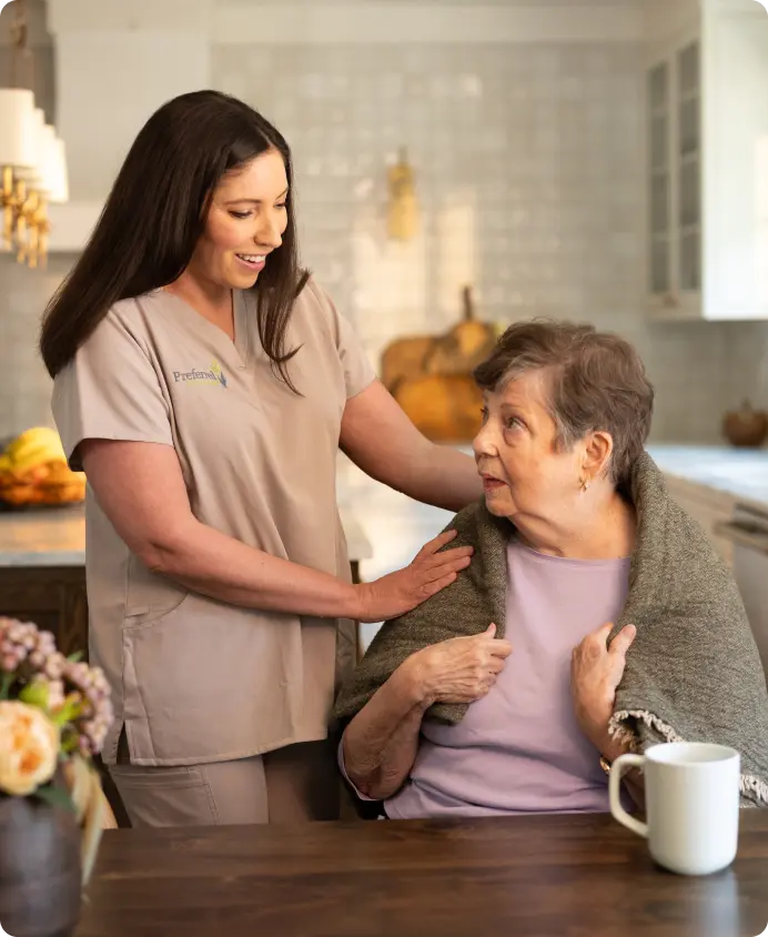 Caregiver assisting elderly woman