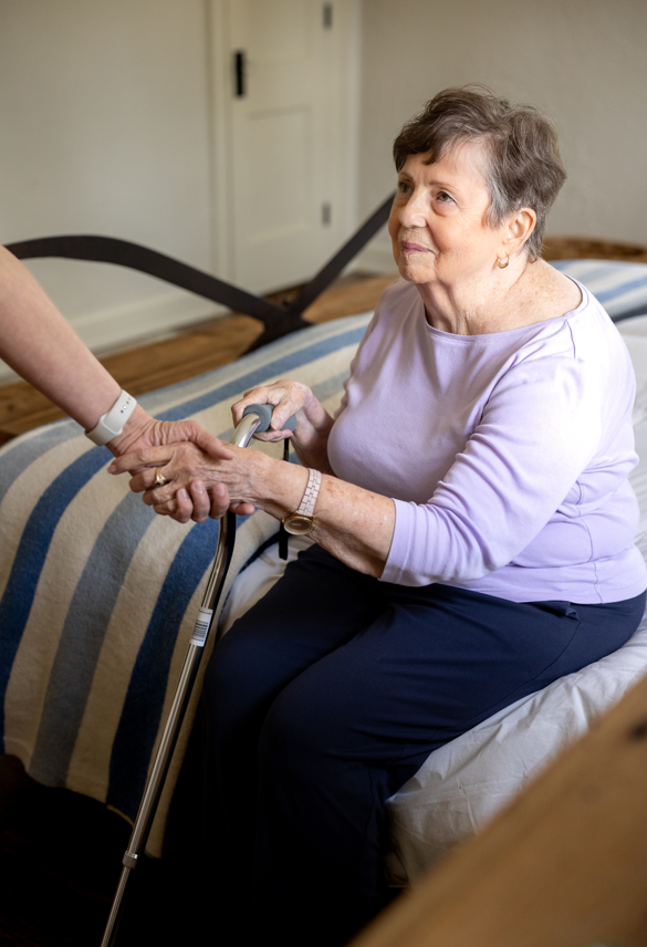 Comfort Care Aand Pain Management Support A woman with a cane assists an older woman, symbolizing compassionate support in end-of-life care services.