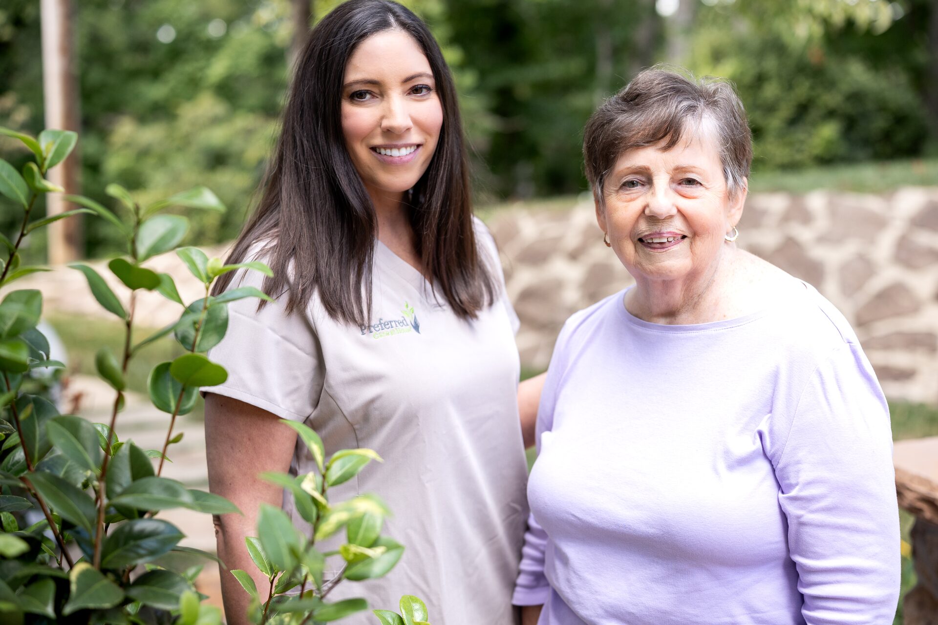 A Preferred Care at Home caregiver sharing a smile with a senior outdoors on the greater Coral Gables area