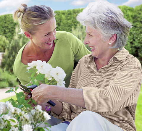 An image of a caregiver helping an elder with daily tasks in a Senior Home Care facility in Virginia Beach, VA.