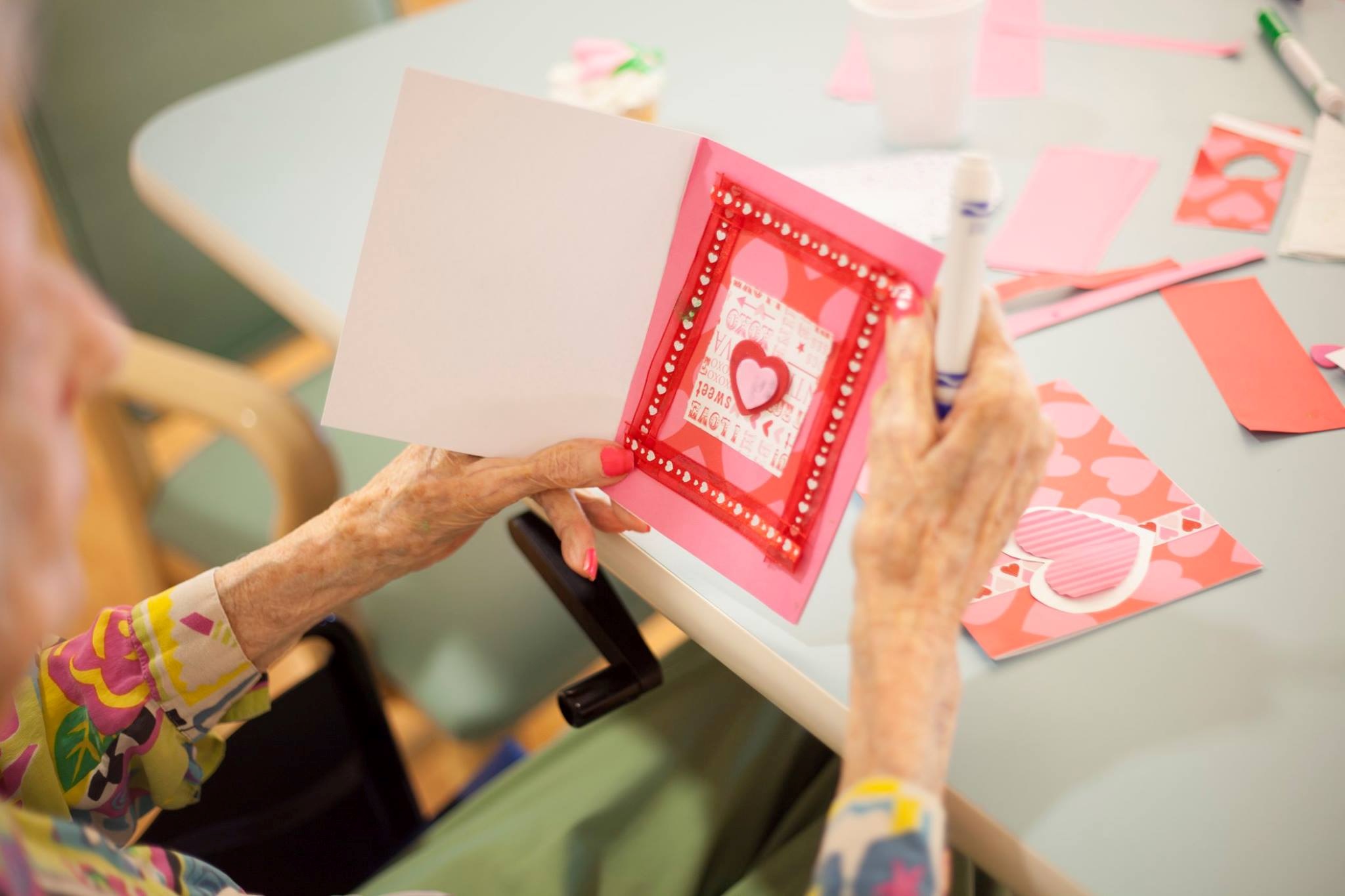 Senior woman enjoys an afternoon making Valentine’s Day cards